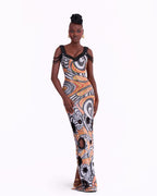 Woman wearing a patterned dress on a white background